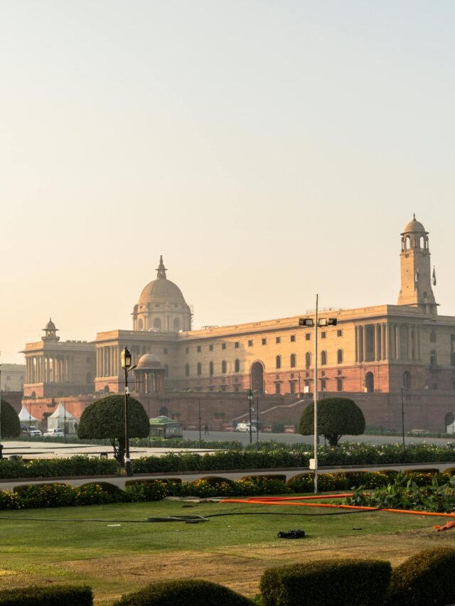 Stunning view of Rashtrapati Bhavan with a clear sky in New Delhi, India, during sunrise.